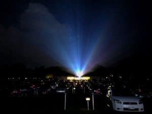 Projection beam light shining over cars at bengies drive-in theatre